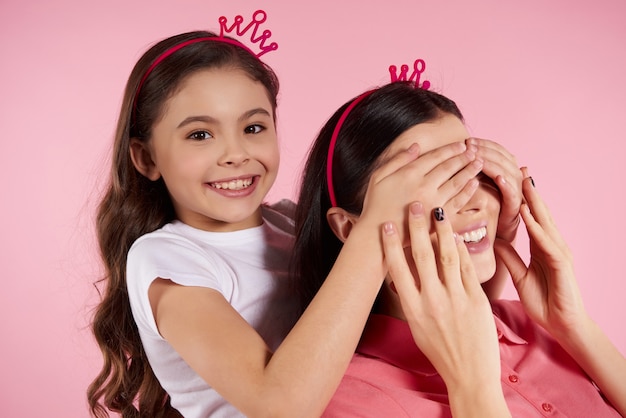 Beautiful mother and daughter in sham crowns