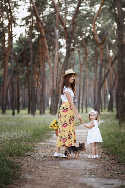 Beautiful mother and daughter on a walk in the forest