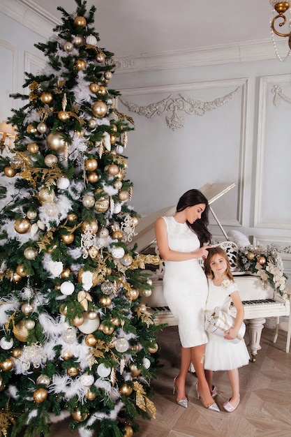 Beautiful mother and little daughter posing 