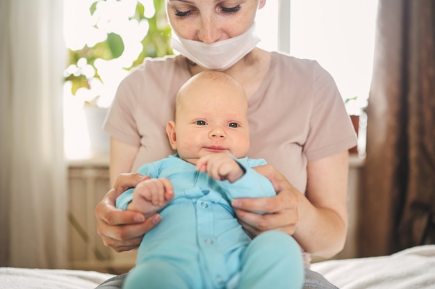 beautiful mother with a mask with her baby