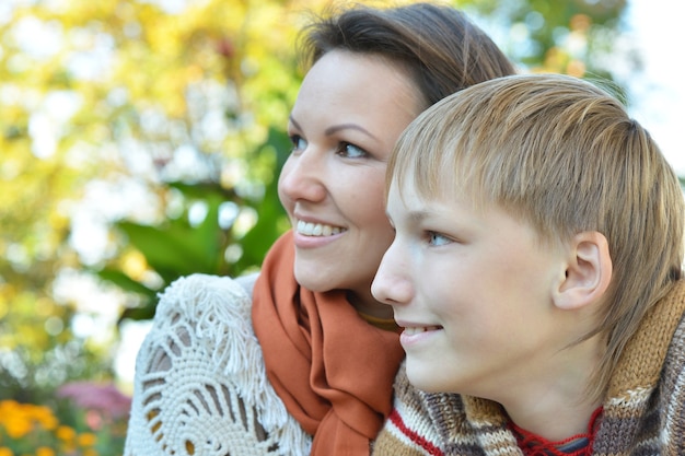 Beautiful mother with son in autumn park