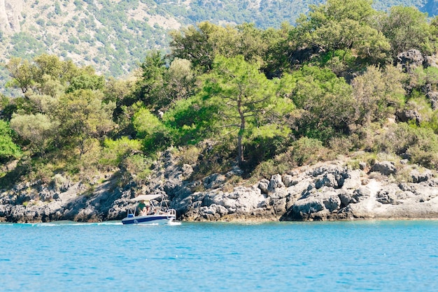 Beautiful motorboat on the background of the rocky coast