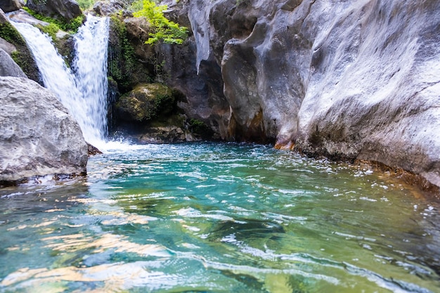 A beautiful mountain gorge with a river and a waterfall