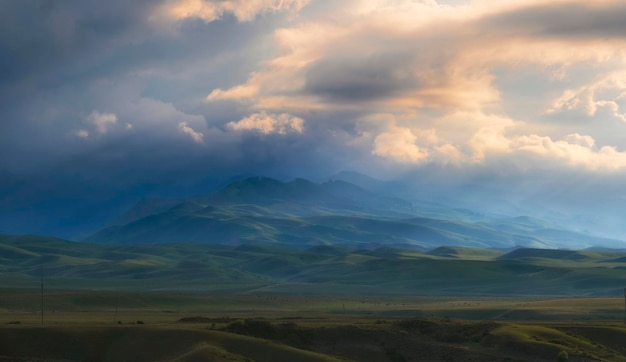 Beautiful mountain landscape with clouds at sunset before the storm