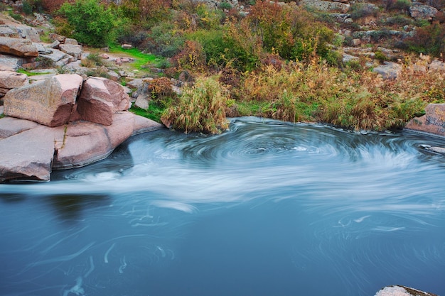 Beautiful mountain river flowing over rocks Flow of water in mountain river close up