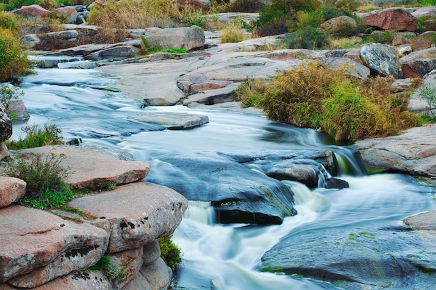 Beautiful mountain river flowing over rocks flow of water in\
mountain river close up