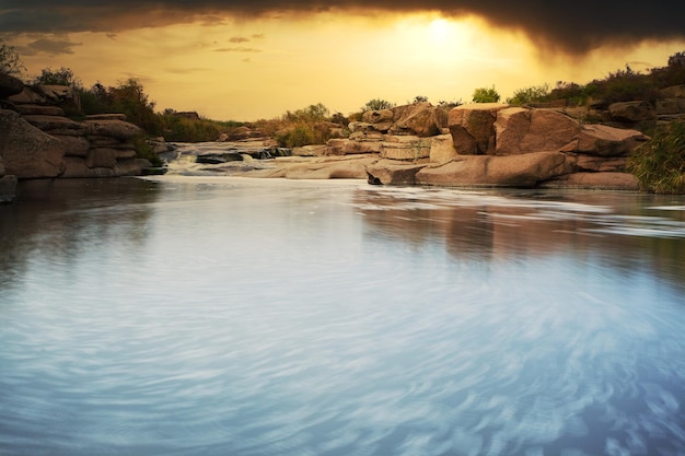 Beautiful mountain river flowing over rocks Flow of water in mountain river close up