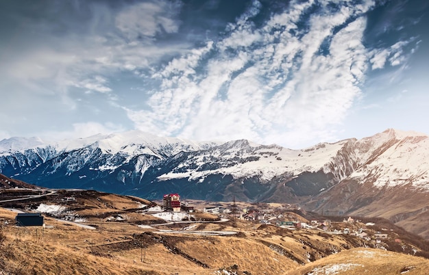 Beautiful mountains landscape in georgia with road and houses in gudauri