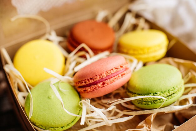 Beautiful multi-colored macaroons in a cardboard box