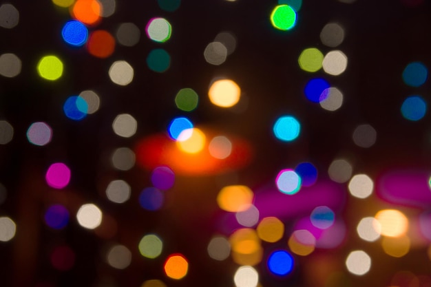 Photo beautiful multicolored blurred bokeh lights holiday glitter background for christmas new years eve celebration with golden garland sparkling