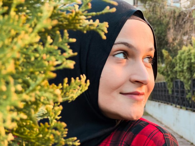 Beautiful Muslim model enjoys nature breathes fresh air in summer garden