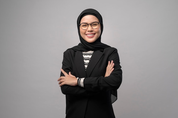 Beautiful muslim woman wearing glasses over white background studio