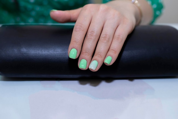 Beautiful nail polish in hand green nail manicure