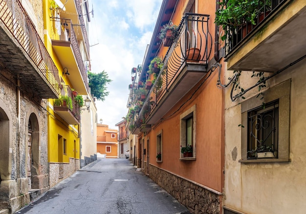 Beautiful narrow medeterranean street with vintage buildings beautiful windows and picturesque balcony with attributes of traditional italian country life