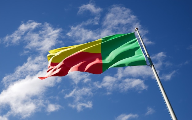 Beautiful national state flag of Benin fluttering at sky