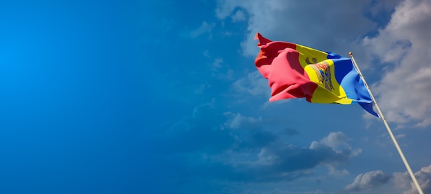 Beautiful national state flag of Moldova on blue sky