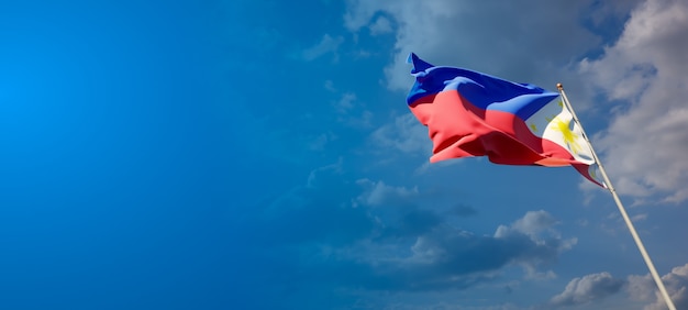 Beautiful national state flag of Philippines on blue sky