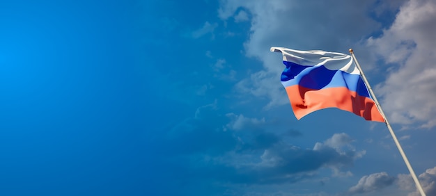 Beautiful national state flag of Russia on blue sky