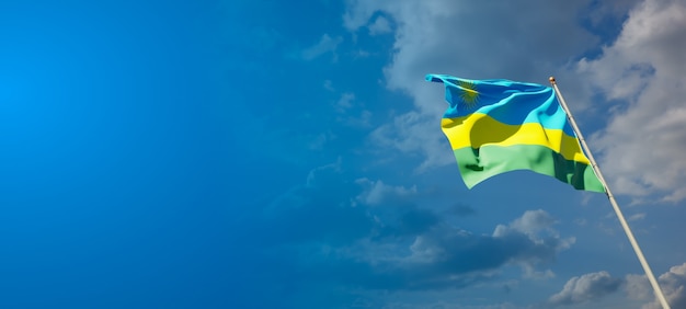 Beautiful national state flag of Rwanda on blue sky