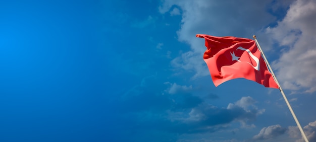 Beautiful national state flag of Turkey on blue sky