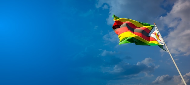 Beautiful national state flag of Zimbabwe on blue sky