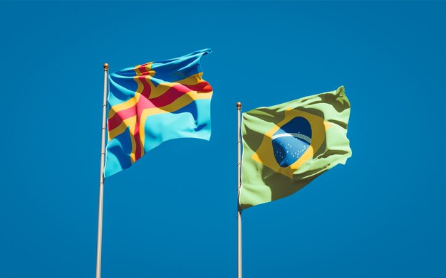 Beautiful national state flags of Brasil and Aland Islands together on blue sky