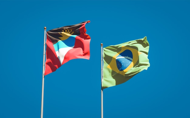 Belle bandiere nazionali dello stato del brasile e antigua e barbuda insieme sul cielo blu