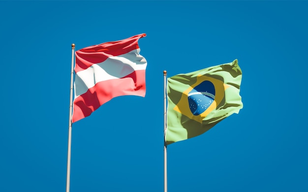 Beautiful national state flags of Brasil and Austria together on blue sky