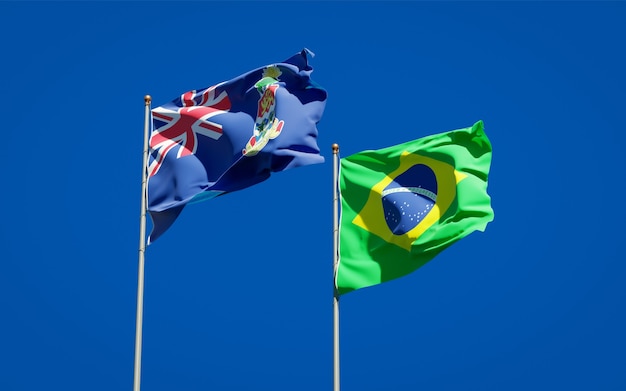 Beautiful national state flags of Brasil and Cayman Islands together on blue sky