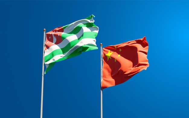 Beautiful national state flags of China and Abkhazia together at the sky 