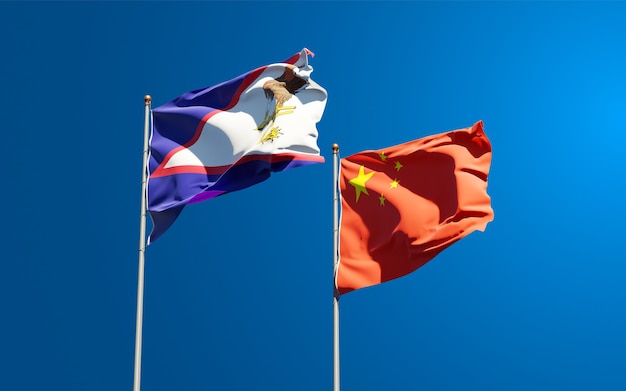 Beautiful national state flags of China and American Samoa together at the sky 