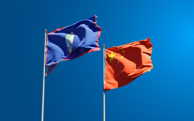 Beautiful national state flags of China and Guam together at the sky 