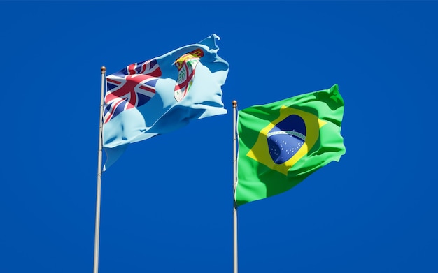 Beautiful national state flags of Fiji and Brasil together on blue sky