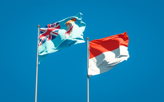 Beautiful national state flags of Fiji and Indonesia together on blue sky