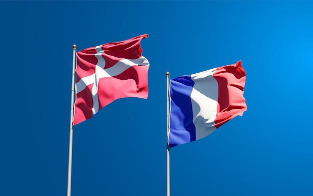 Beautiful national state flags of France and Denmark together at the sky 