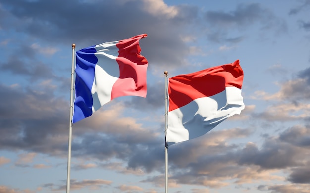 Beautiful national state flags of France and Indonesia together on blue sky