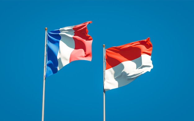 Beautiful national state flags of France and Indonesia together on blue sky