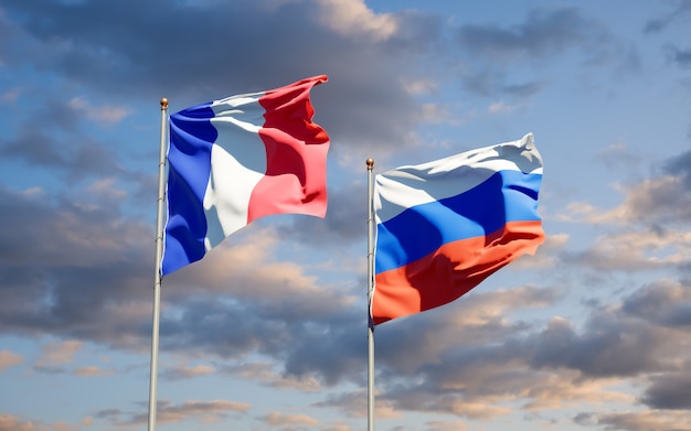 Beautiful national state flags of France and Russia together on blue sky. 3D artwork