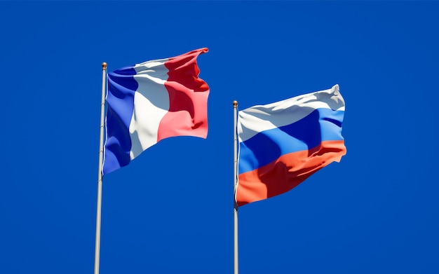 Beautiful national state flags of France and Russia together on blue sky. 3D artwork