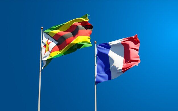 Beautiful national state flags of France and Zimbabwe together at the sky 