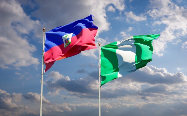 Beautiful national state flags of Haiti and Nigeria together on blue sky