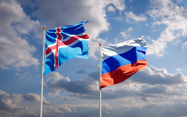 Beautiful national state flags of Iceland and Russia together on blue sky. 3D artwork