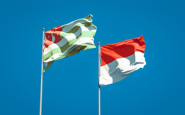 Beautiful national state flags of Indonesia and Abkhazia together on blue sky