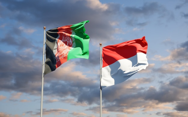 Beautiful national state flags of Indonesia and Afghanistan together on blue sky