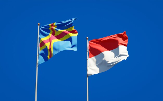 Beautiful national state flags of Indonesia and Aland Islands together on blue sky