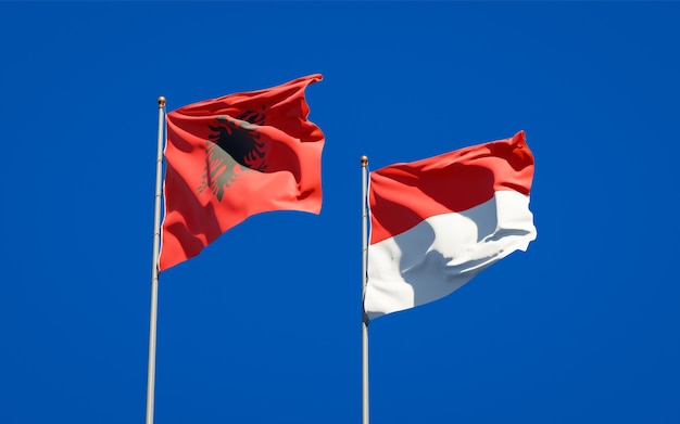 Beautiful national state flags of Indonesia and Albania together on blue sky