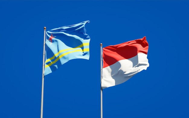 Beautiful national state flags of Indonesia and Aruba together on blue sky