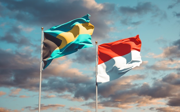 Beautiful national state flags of Indonesia and Bahamas together on blue sky