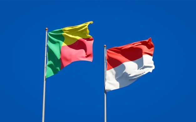 Beautiful national state flags of Indonesia and Benin together on blue sky