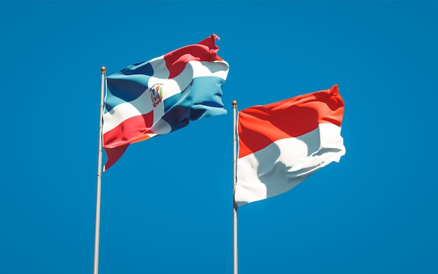 Beautiful national state flags of Indonesia and Dominican Republic together on blue sky